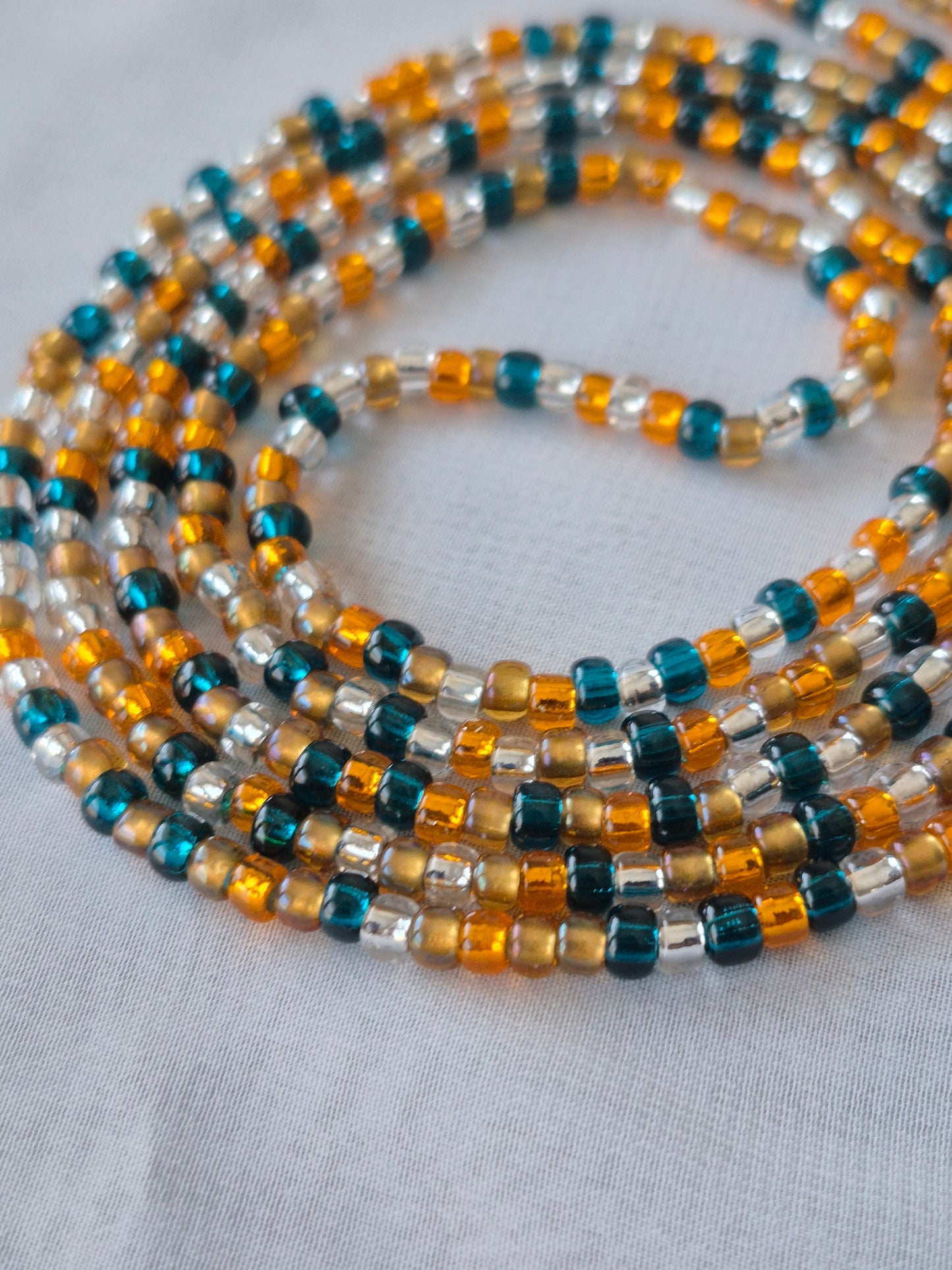 Orange, blue, clear and bronze tie on waistbead