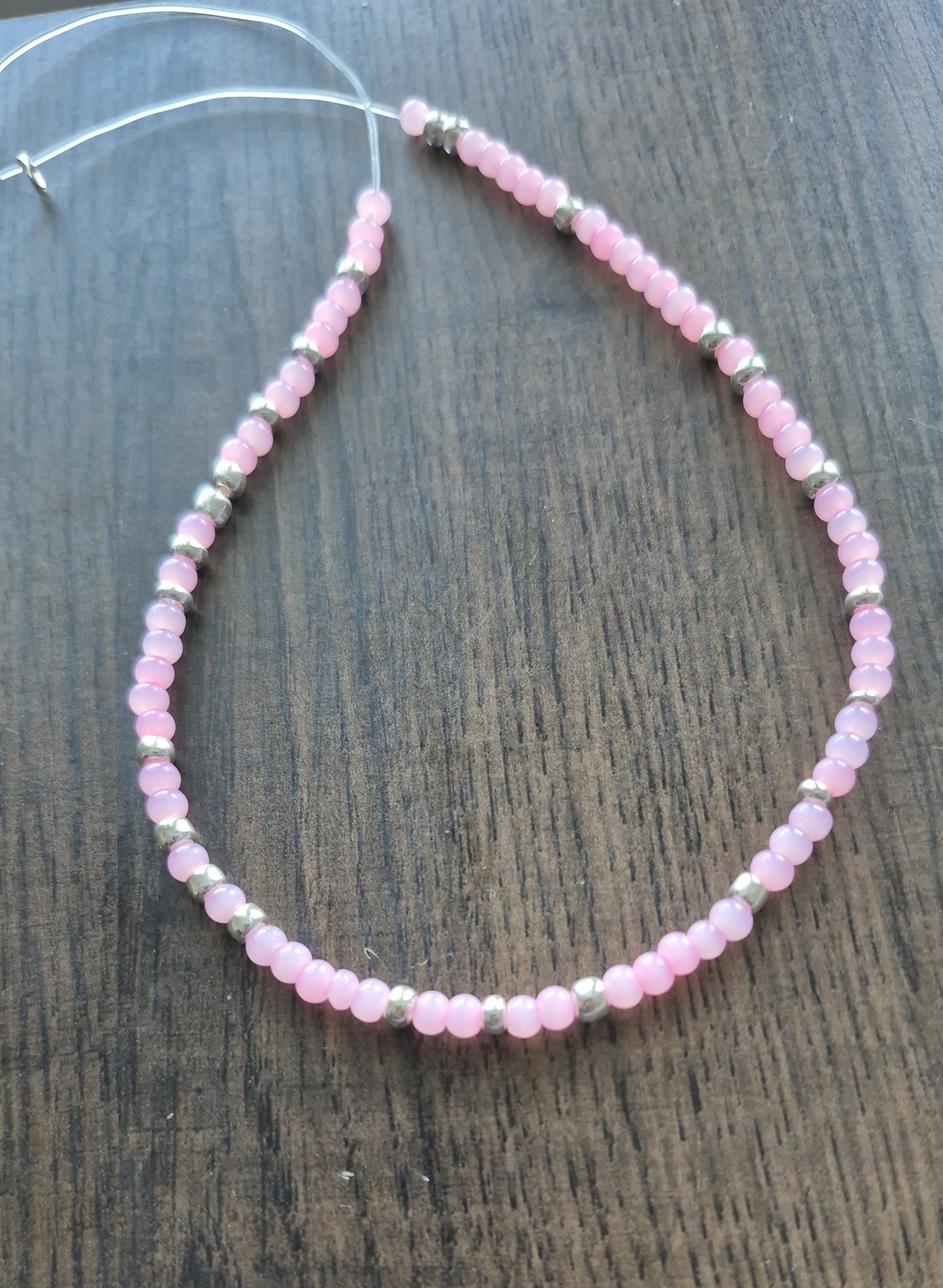 Pink cats eye and silver tie on anklet