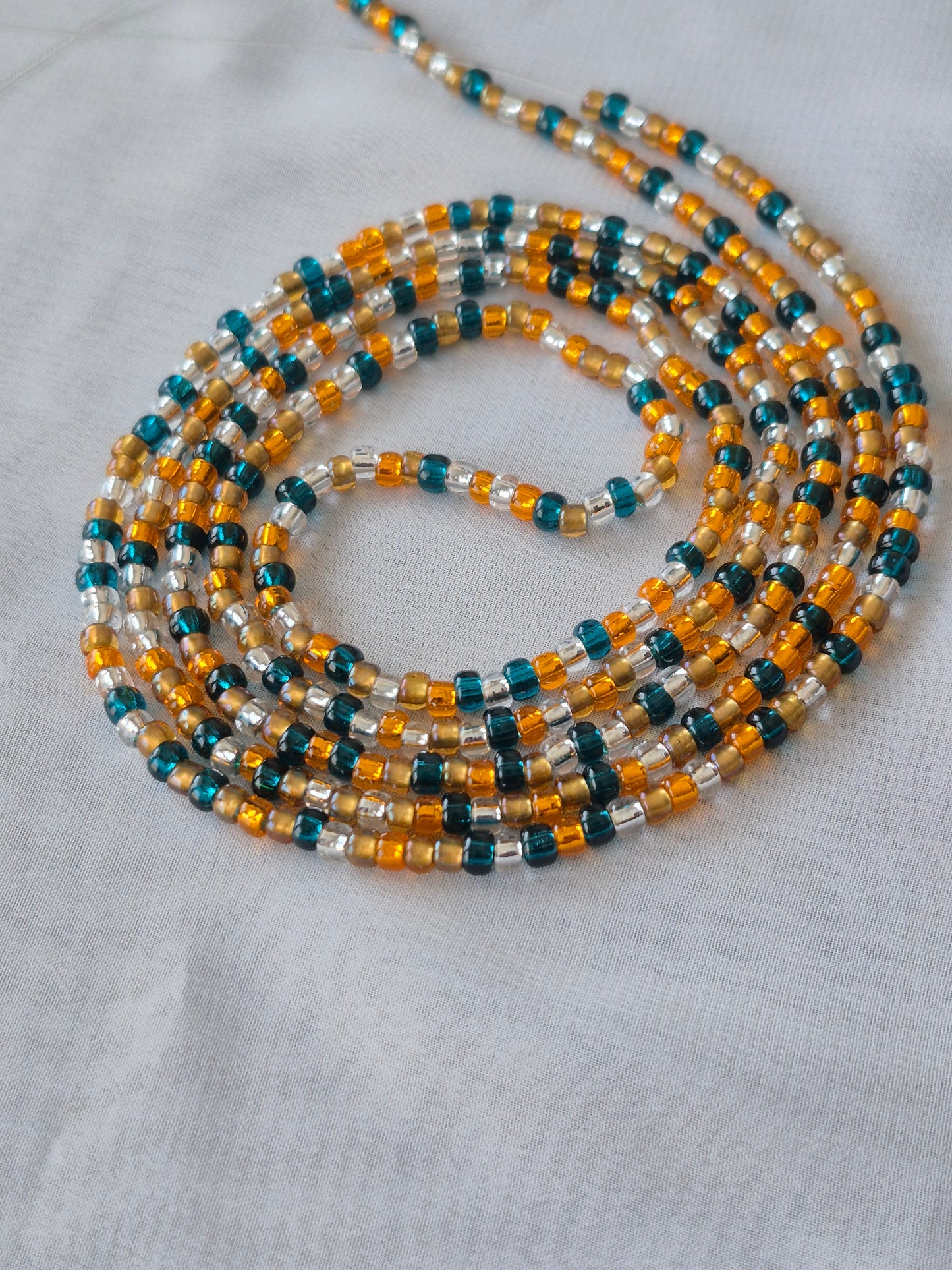 Orange, blue, clear and bronze tie on waistbead