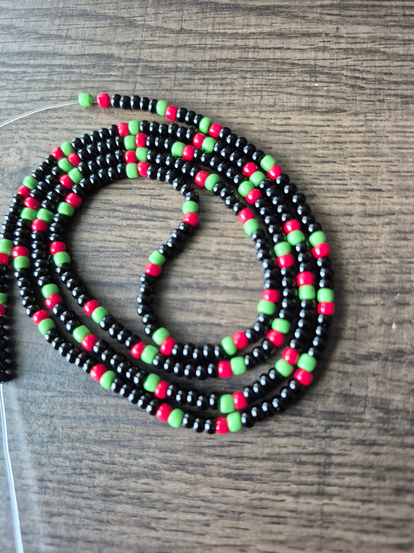Pan African flag themed black, red and green tie on waistbead