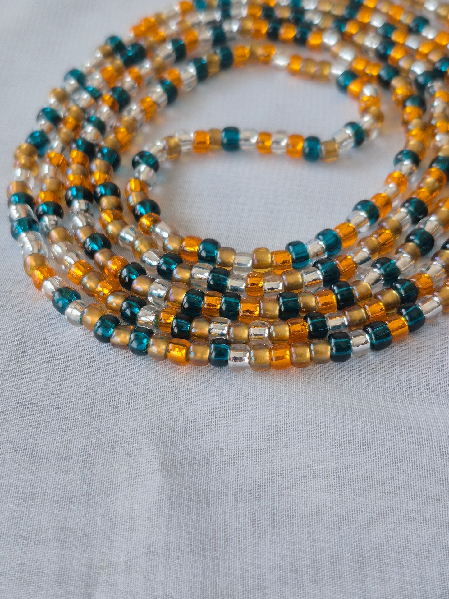Orange, blue, clear and bronze tie on waistbead