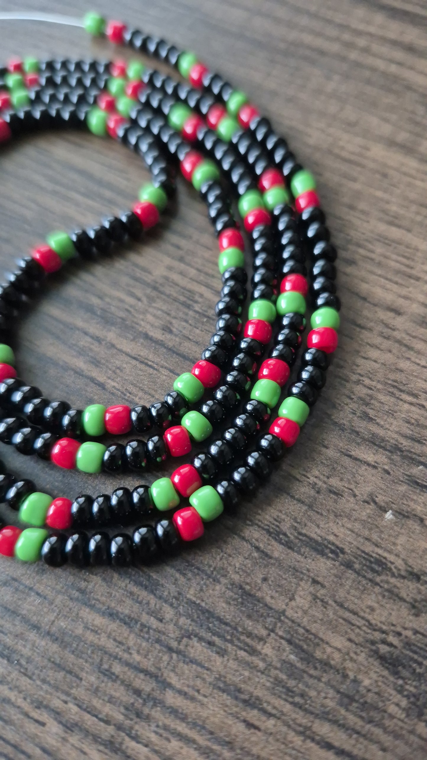 Pan African flag themed black, red and green tie on waistbead