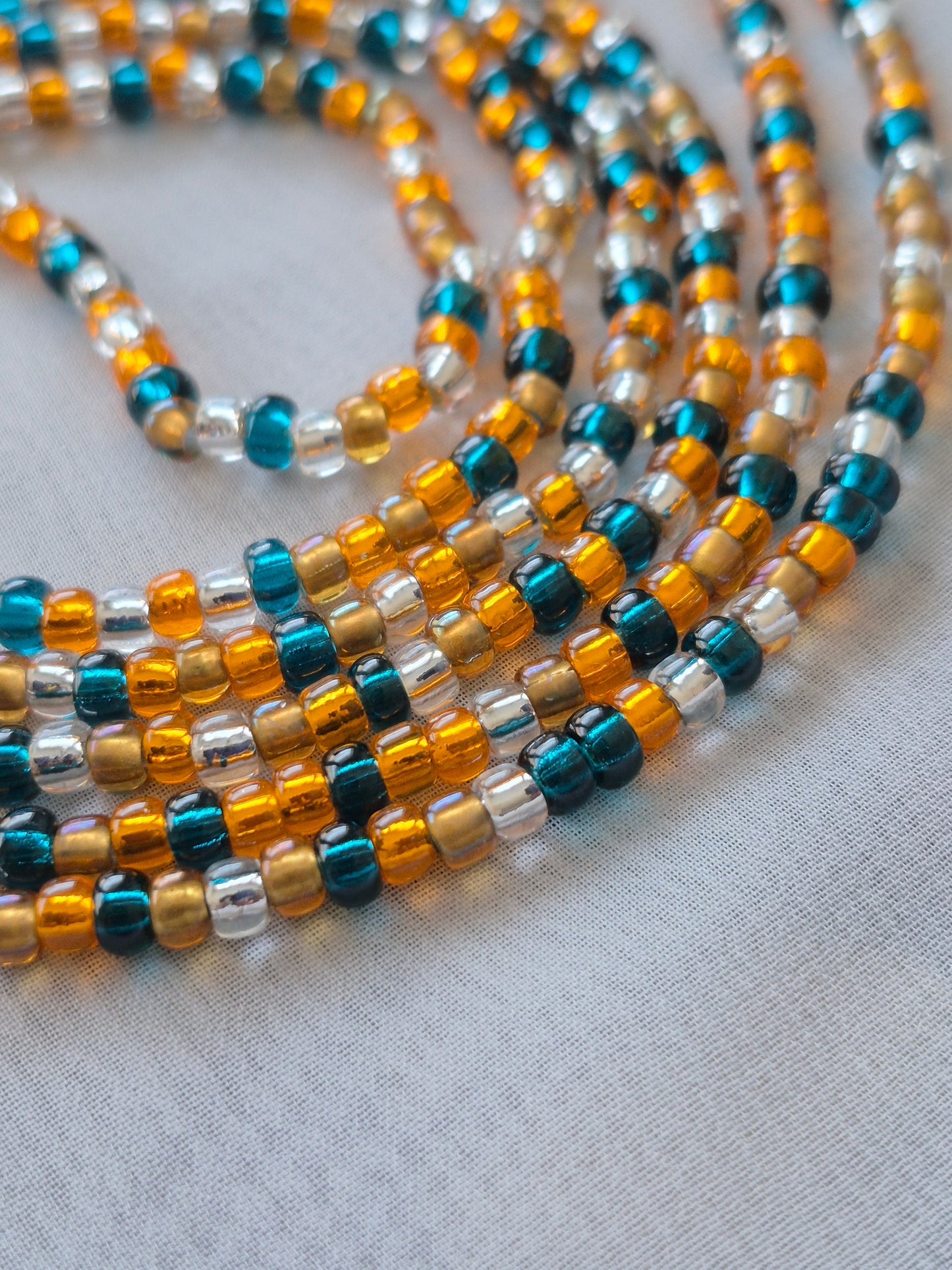 Orange, blue, clear and bronze tie on waistbead