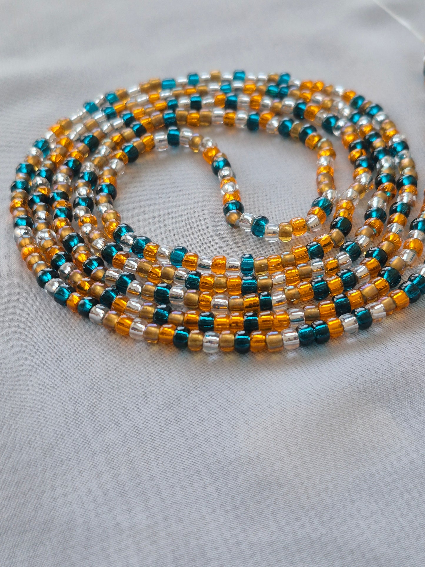 Orange, blue, clear and bronze tie on waistbead