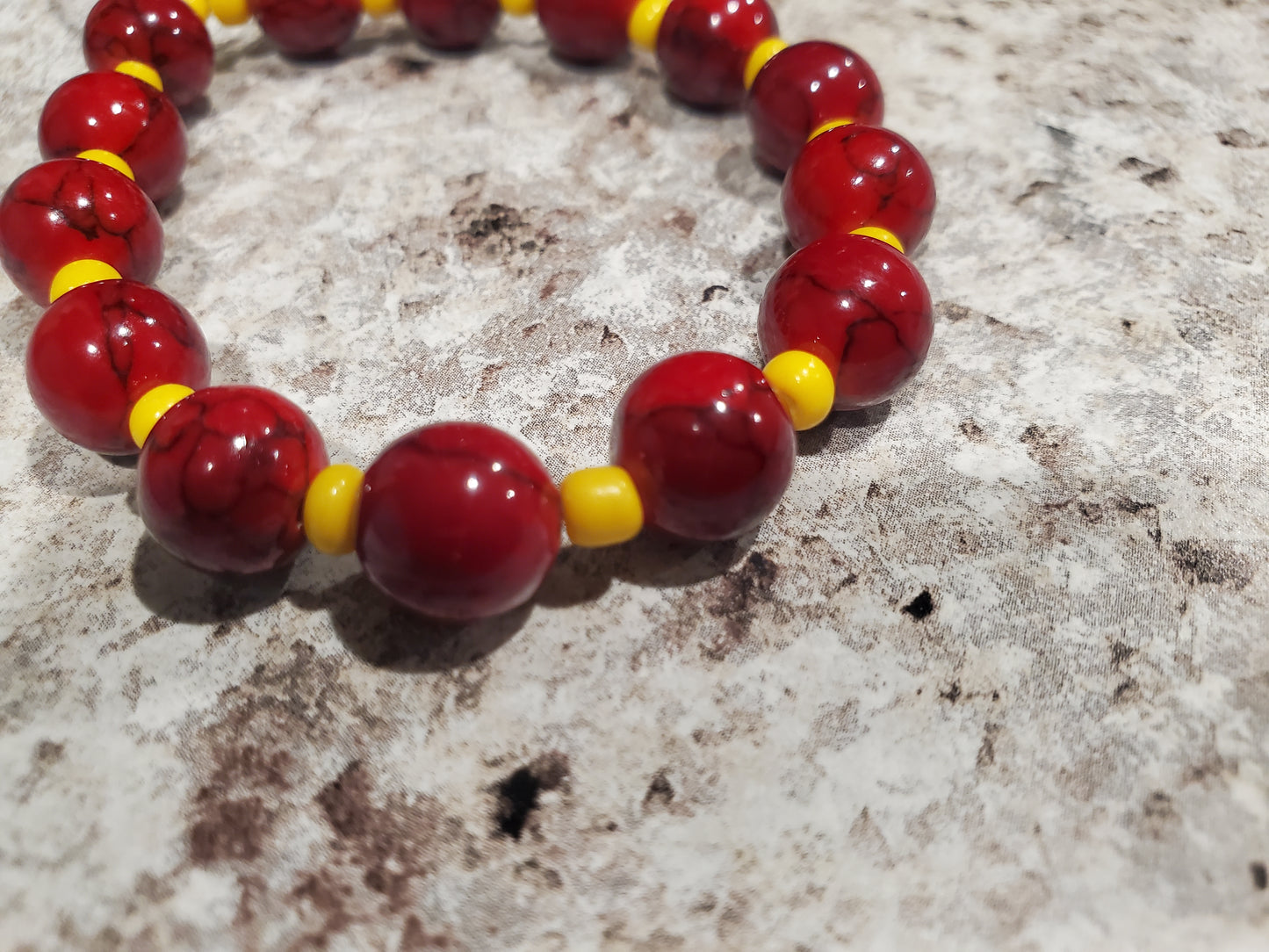 Red dyed quartz gemstone and yellow bead bracelet