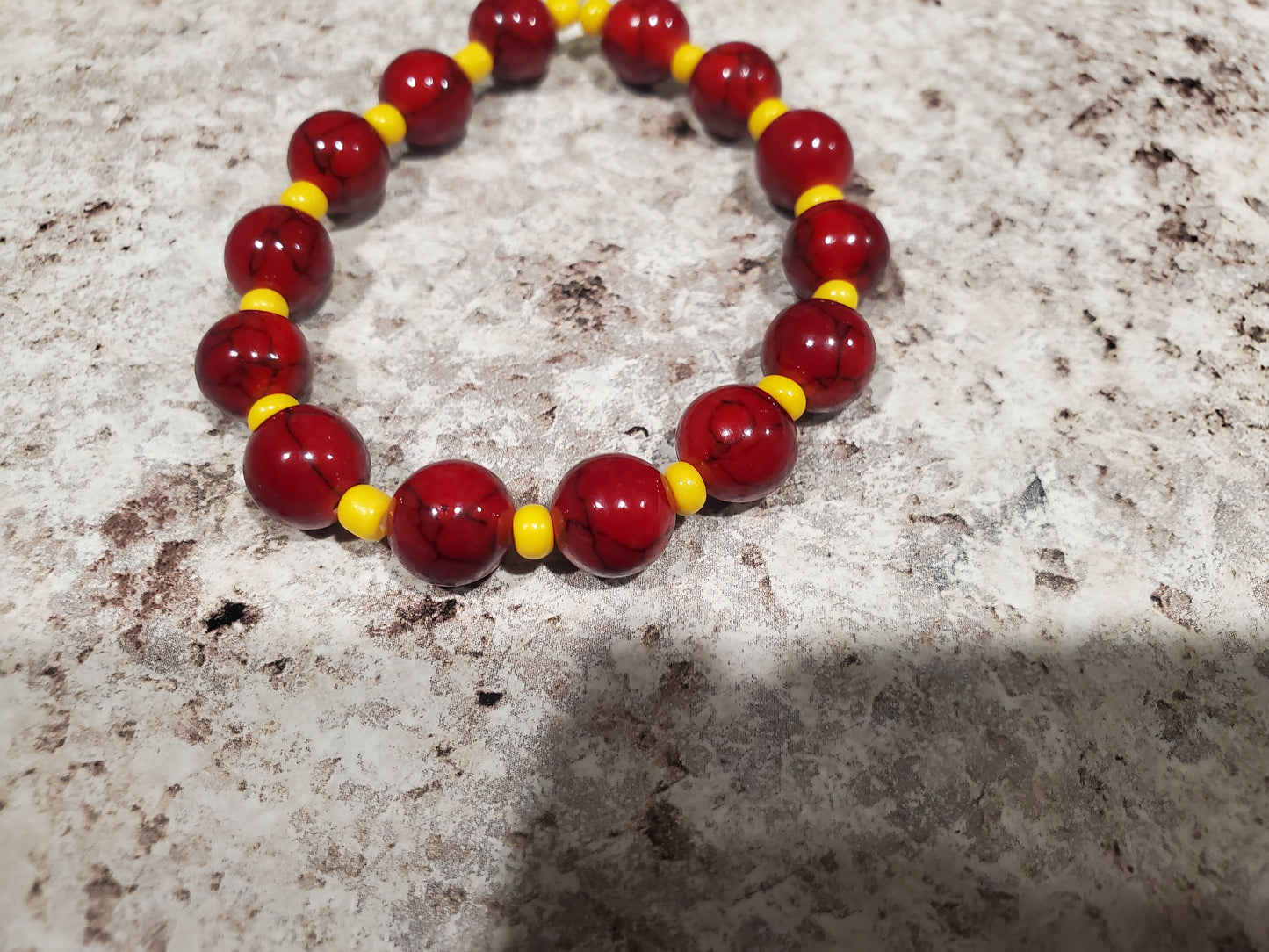 Red dyed quartz gemstone and yellow bead bracelet