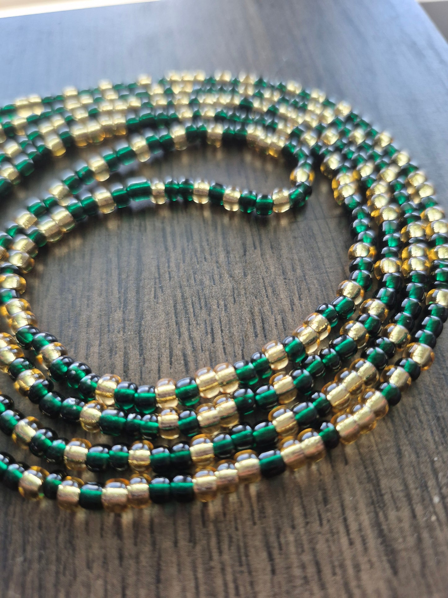 Emerald green and gold tie on waistbead