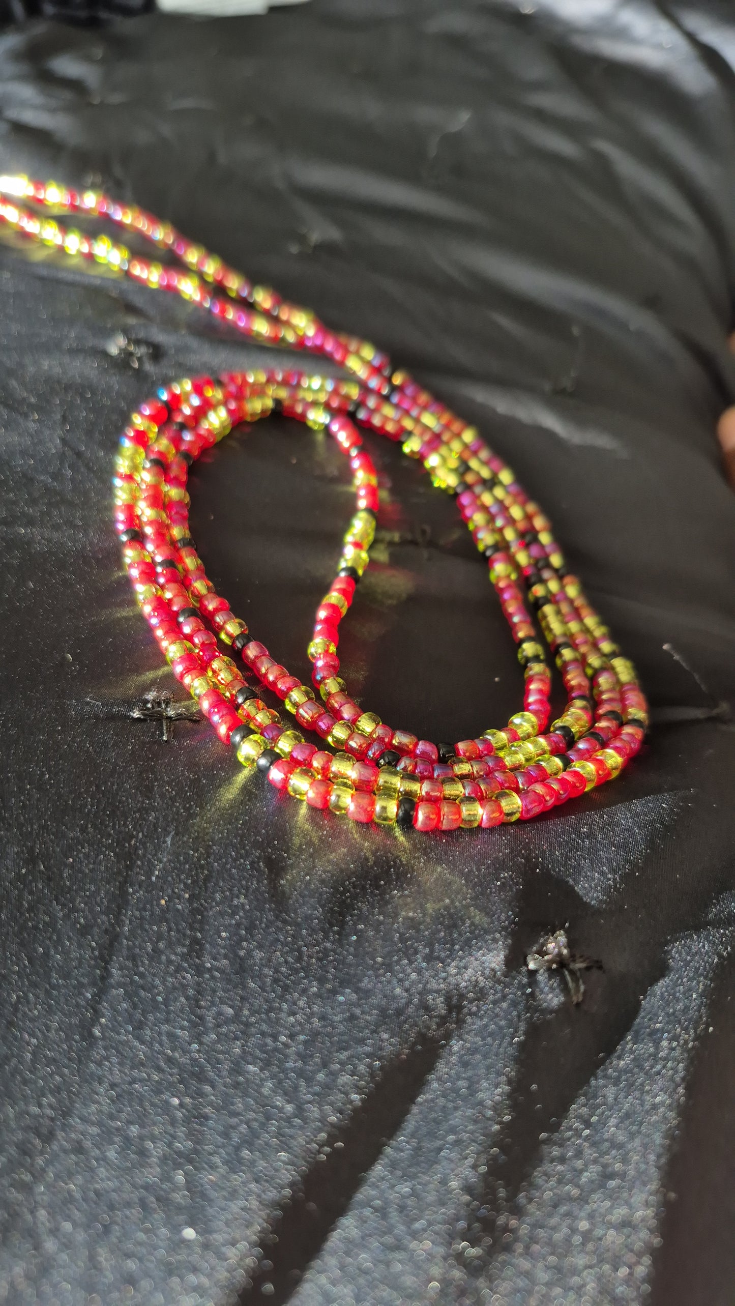 Red, green and black tie on handcrafted waistbead