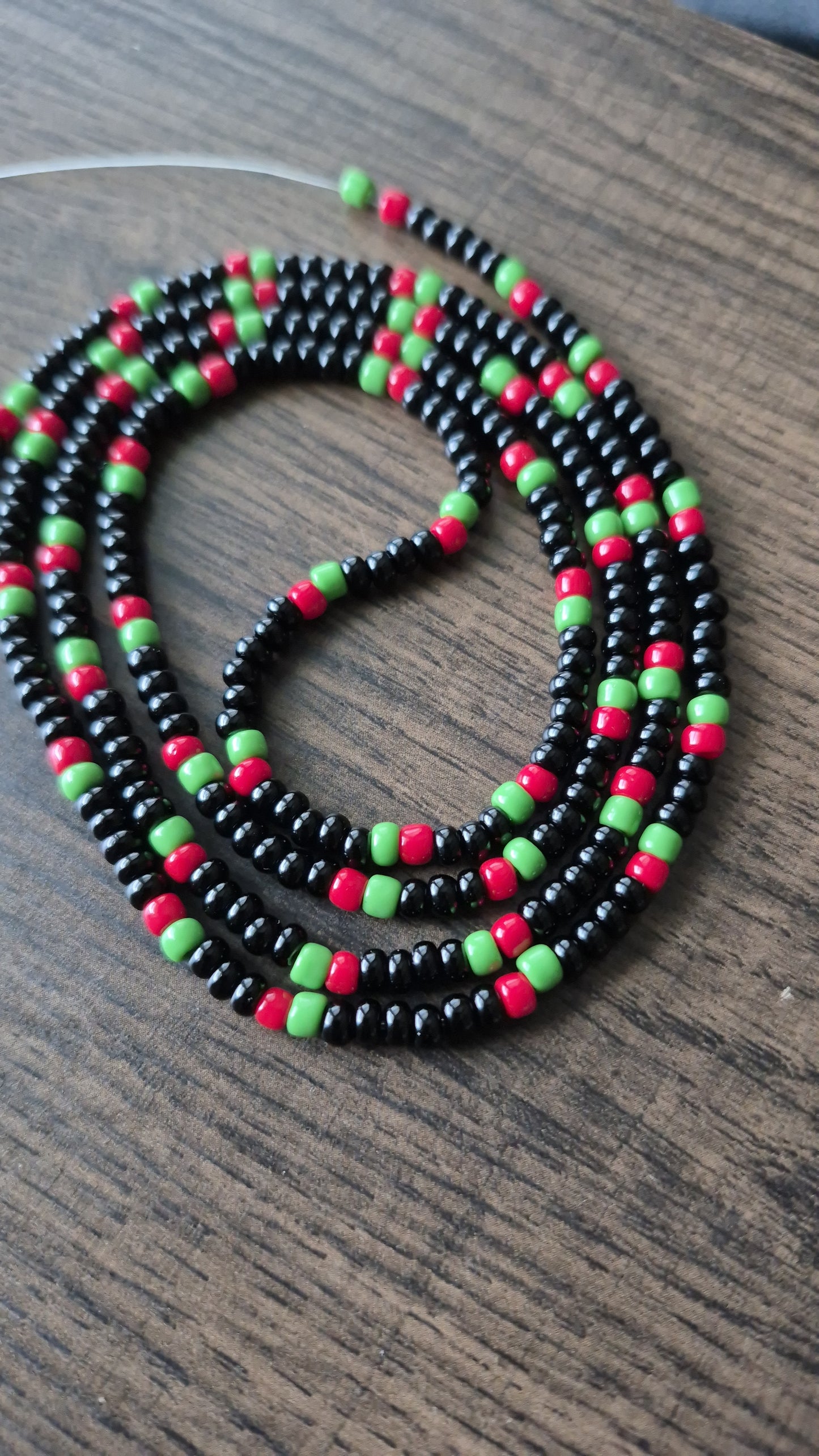 Pan African flag themed black, red and green tie on waistbead