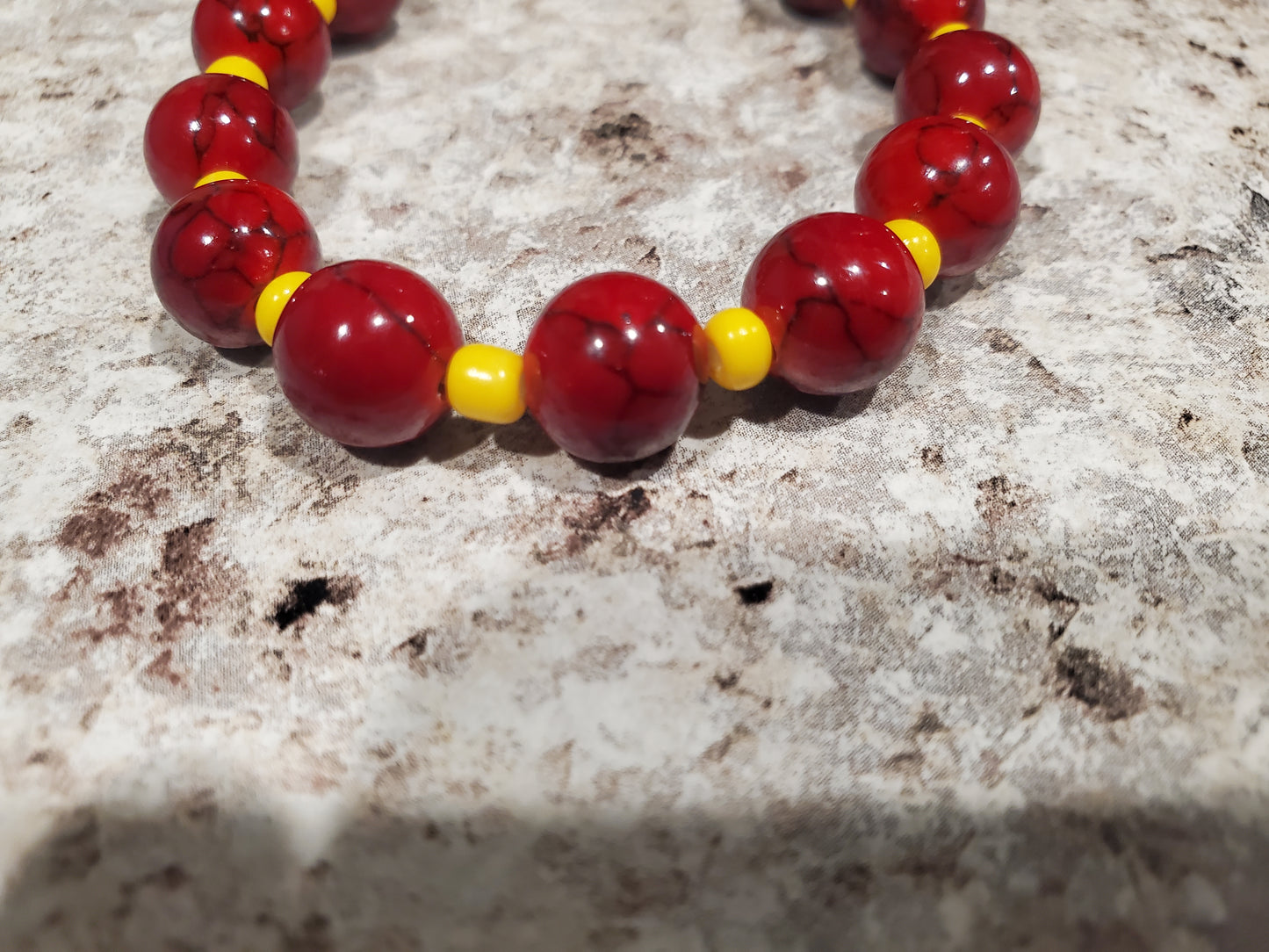 Red dyed quartz gemstone and yellow bead bracelet
