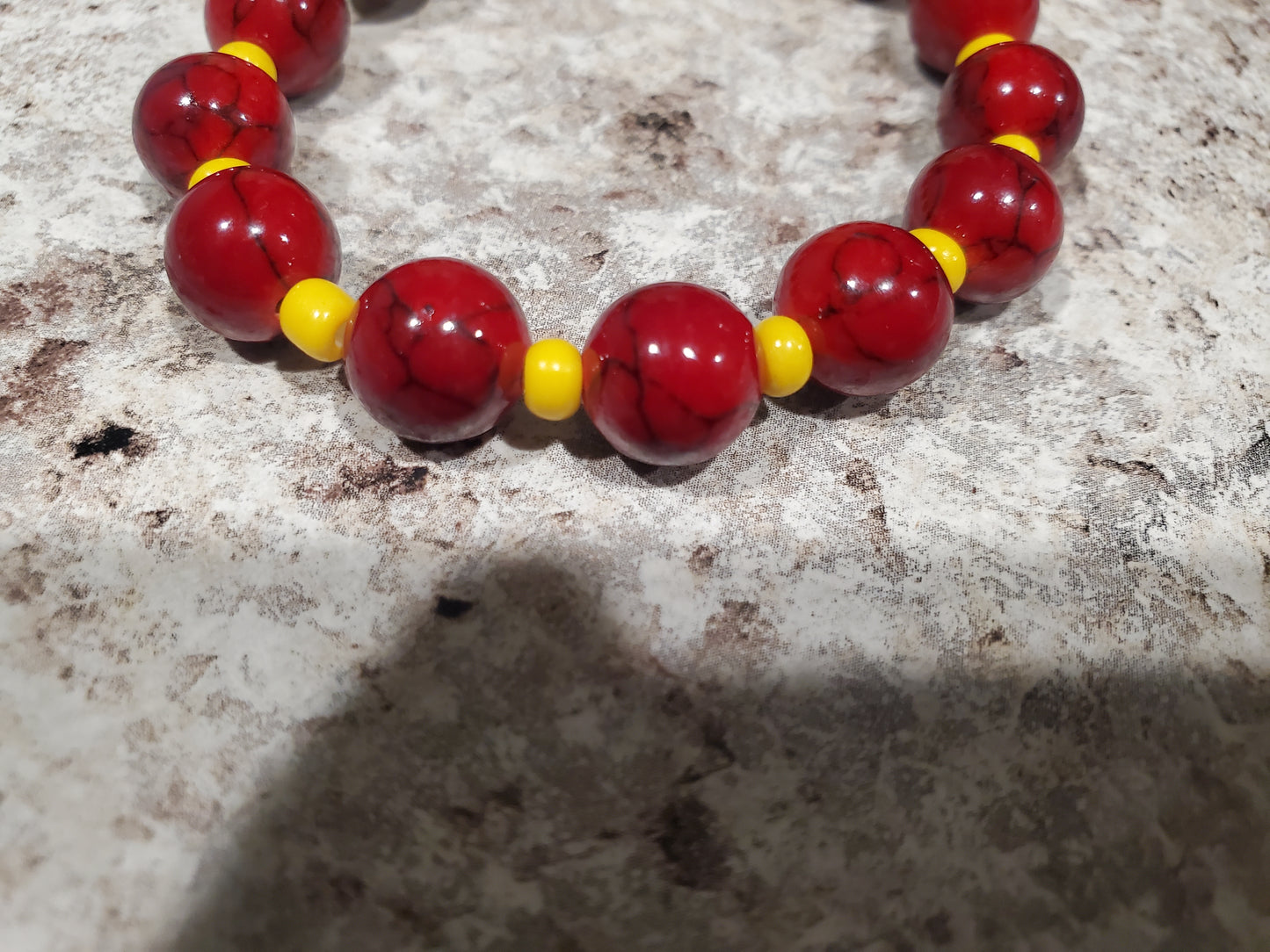 Red dyed quartz gemstone and yellow bead bracelet